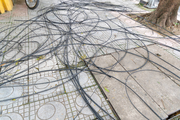 Power cord and Cable power tangled on the Walkway, floor and square drain hose. - Photo, Image