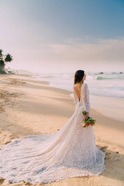 portrait of bride in full growth on tropical beach - 写真・画像