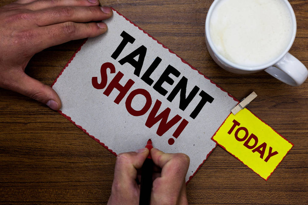 Conceptual hand writing showing Talent Show. Business photo text Competition of entertainers show casting their performances Man holding marker notebook reminder wooden table cup coffee. - Photo, Image