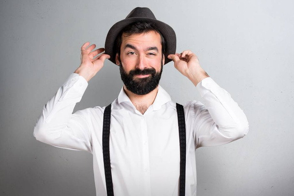 Handsome hipster man with beard on grey background - Fotoğraf, Görsel