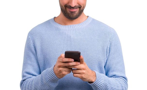 携帯電話を用いたブルーのセーターを持つ男 - 写真・画像