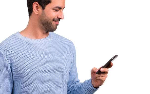 Man with blue sweater using mobile phone - Photo, Image