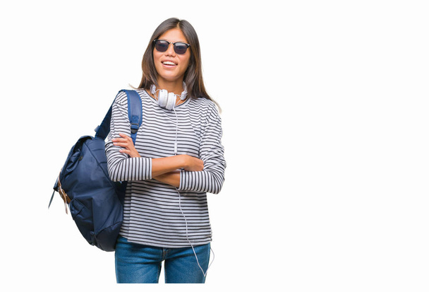 Jeune étudiante asiatique portant casque et sac à dos sur fond isolé visage heureux souriant avec les bras croisés regardant la caméra. Personne positive
. - Photo, image