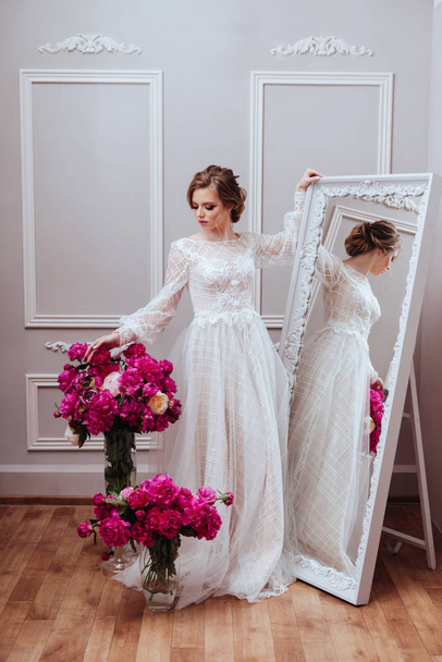 Beautiful bride with flowers peony. beauty, makeup, wedding and cosmetology  - Фото, изображение