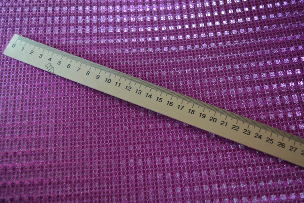 Light wooden mathematical ruler on a pink reflective background. - 写真・画像