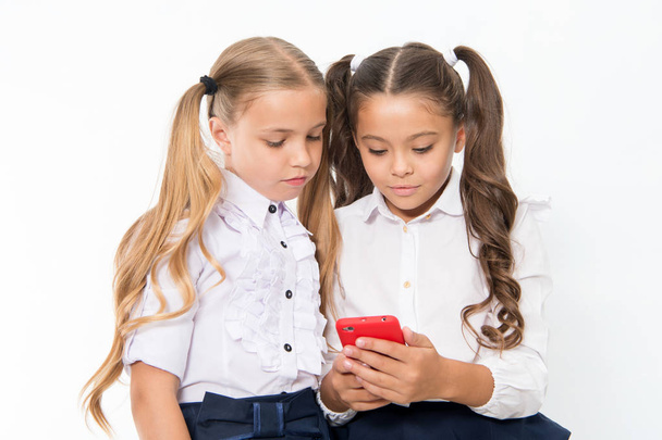 Little children depend on mobile phone. Girls text sms with mobile phone. depend. - Фото, зображення