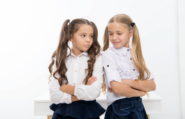 Little girls in school uniform keep arms crossed. Back to school and looking good in new school uniform. little girls. - Photo, Image