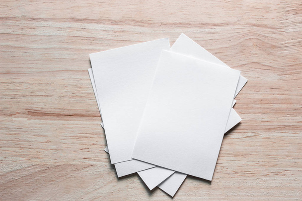 Blank portrait mock-up paper. brochure magazine isolated on brown wooden table, changeable background / white paper isolated on wood - Foto, afbeelding
