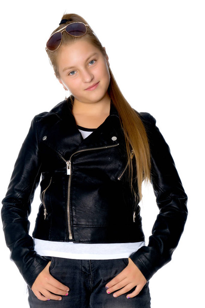 A teenage girl in a leather jacket and jeans. - Photo, Image