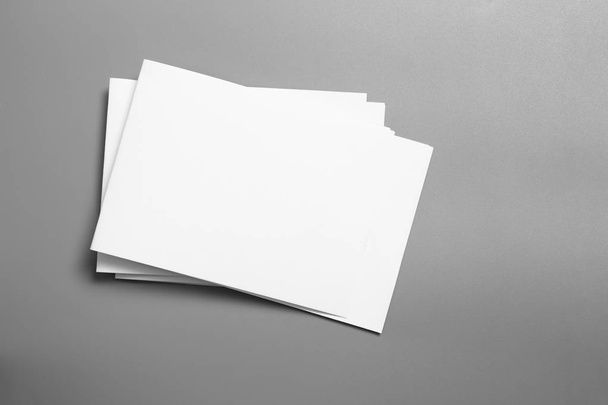 Blank portrait mock-up paper. brochure magazine isolated on gray, changeable background / white paper isolated on gray - Fotó, kép