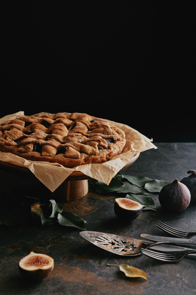 close up view of homemade pie on cake stand on grungy tabletop with black background - Fotografie, Obrázek