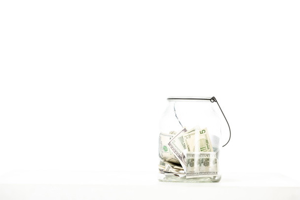 glass jar with dollar banknotes isolated on white background  - Φωτογραφία, εικόνα