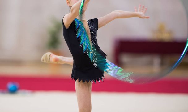 Girl in beautiful gymnastic dress doing exercise - Photo, Image