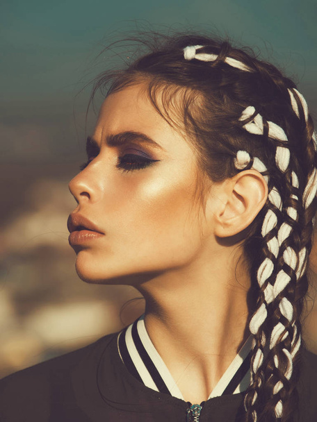 Cute fashionable girl with stylish makeup and long braids - Foto, afbeelding