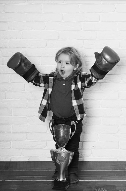 happy kid winner in boxing glove winning golden champion cup - Фото, изображение