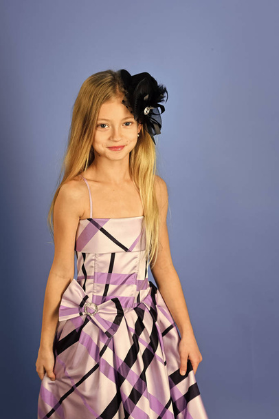 Child girl in stylish glamour elegant dress. child girl has beautiful hair. - Фото, зображення