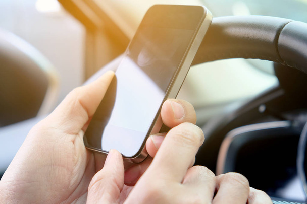 using mobile smart phone while driving the car - Valokuva, kuva