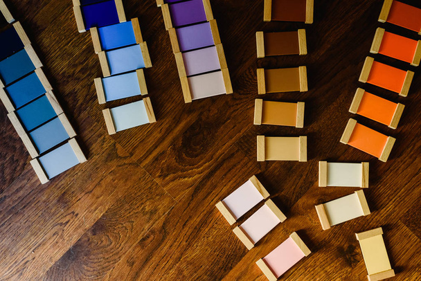 Montessori color tablets on wooden floor background - Фото, изображение