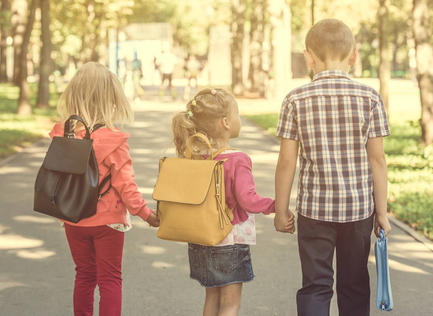Little pupils walking home from school - Φωτογραφία, εικόνα