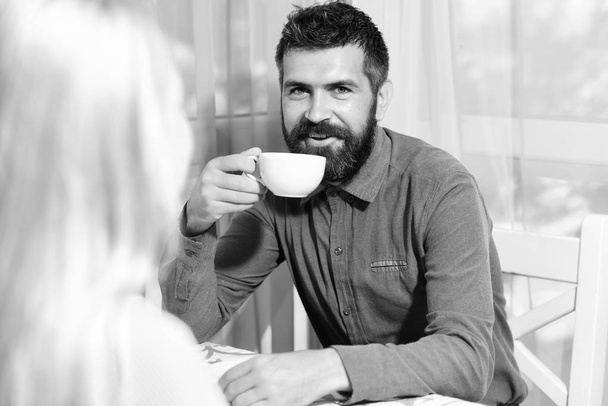Couple in love holds cups of coffee at table - Photo, Image