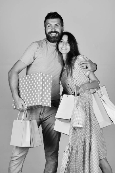 Guy with beard and girl with smiling faces do shopping. - Foto, afbeelding