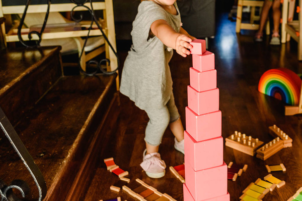 Children playing with pink tower in a Montessori class - Photo, Image