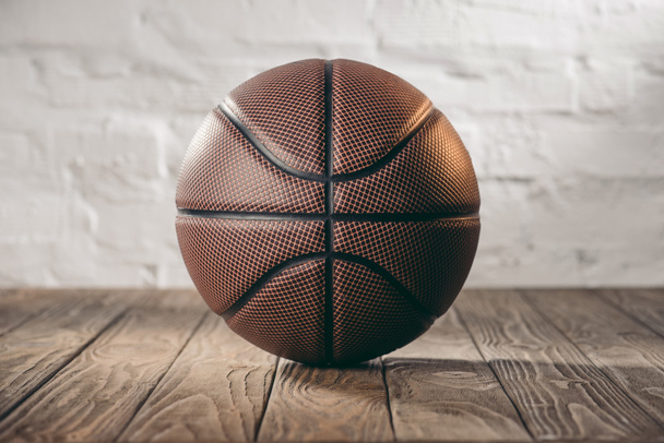 brown leather basketball ball on wooden floor - Photo, Image