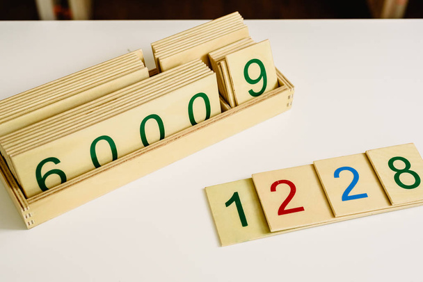Wooden numbers in tables to learn mathematics in a Montessori classroom. - Photo, Image