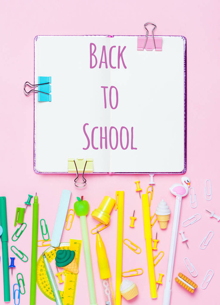Colorful pink background with various School accessories are laid out in the form of a rainbow. Frame with empty space in center. Flat lay top view. Study arrangement. Welcome back to school text. - Foto, Imagem