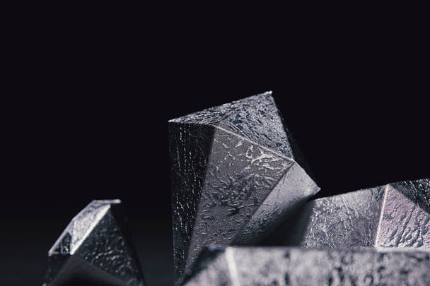 close-up view of shiny faceted silver pieces on black - Fotó, kép