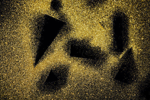 musta muotoja kultainen kimalteleva tausta
 - Valokuva, kuva