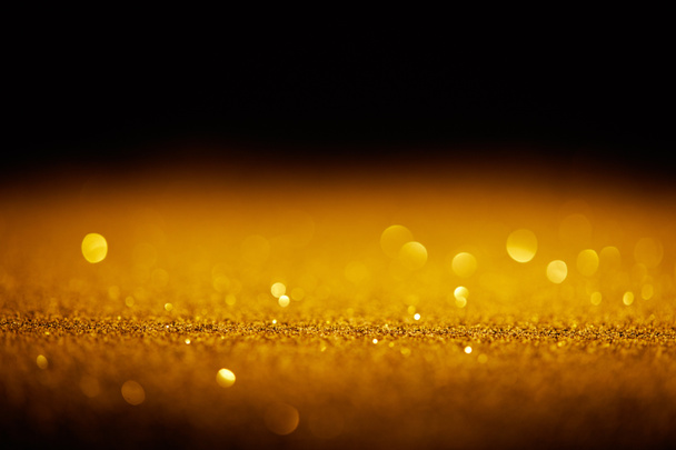 chispa brillo de oro con bokeh sobre fondo negro
 - Foto, Imagen