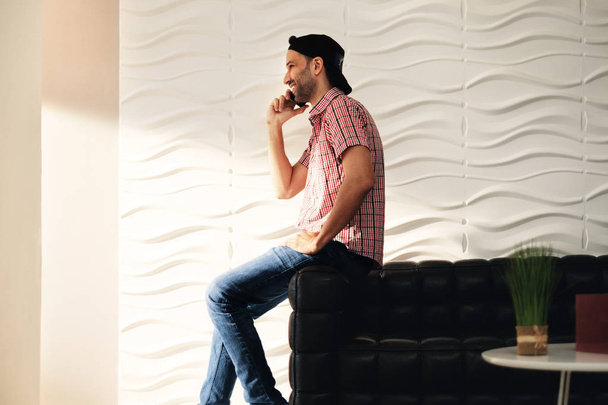 Young Latino Man Talking On Cell Phone At Home - Valokuva, kuva