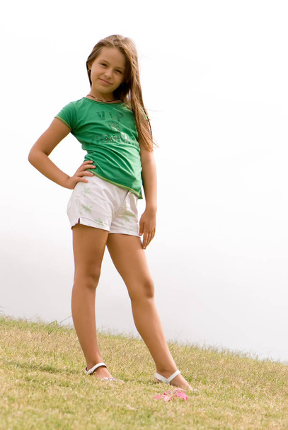 full length portrait of happy girl standing on foggy background - Photo, image