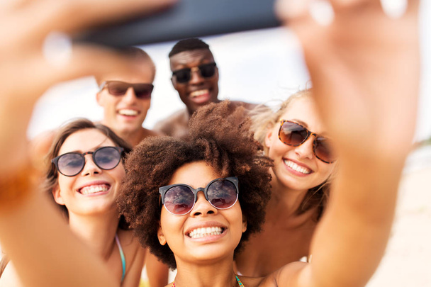 happy friends taking selfie on summer beach - Photo, image