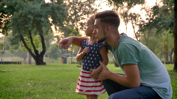schöner Vater zeigt seine kleine Tochter auf die Mutter, sie rennt zu ihr, Familienkonzept - Filmmaterial, Video