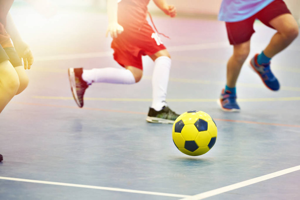 Children playing soccer with yellow football indoors - Φωτογραφία, εικόνα