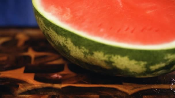  Red watermelon on a wood cutting board.  - Video