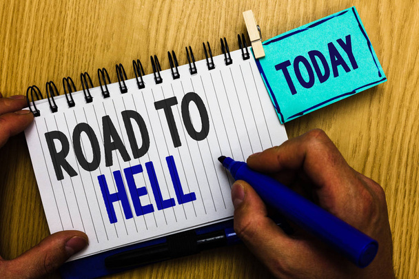 Conceptual hand writing showing Road To Hell. Business photo showcasing Extremely dangerous passageway Dark Risky Unsafe travel Man holding marker expressing ideas notebook reminder wood. - Photo, Image