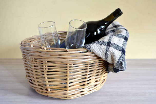 wicker picnic basket with a blanket, bottle of wine, bread and glasses  - Photo, Image