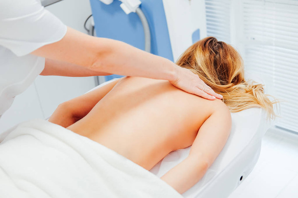 Rubber woman giving a massage to her patient. Health care concept. - Fotó, kép
