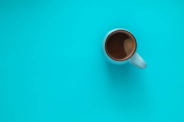 Cup of coffee on blue background. Concept winter comfort, morning coffee, warm in middle of cold. Top view. Flat lay. - Foto, Imagen