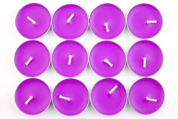 12 colorful lilac candles on white background close-up top view - Fotó, kép