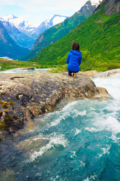 Travel, beauty in nature. Tourist woman looking at Videfossen (called Buldrefossen) waterfall in Norway Sogn og Fjordane - Фото, изображение