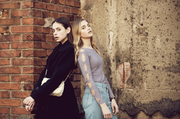 girls near brick textured wall, beauty and fashion - Foto, afbeelding
