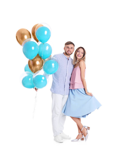 Young couple with air balloons on white background - Fotografie, Obrázek