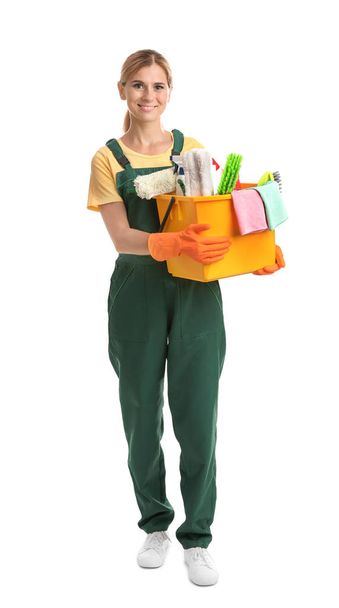 Female janitor with cleaning supplies on white background - Valokuva, kuva