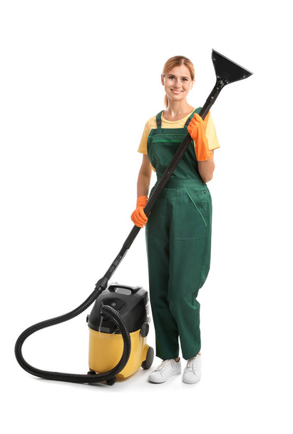 Female janitor with carpet cleaner on white background - Photo, Image