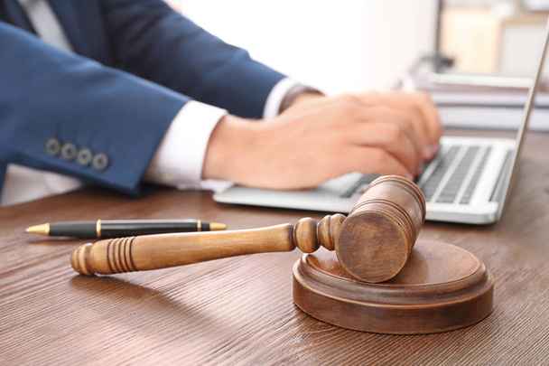 Gavel and blurred lawyer working with laptop on background - Photo, Image