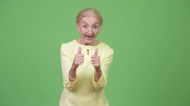 Happy senior businesswoman giving two thumbs up - Felvétel, videó